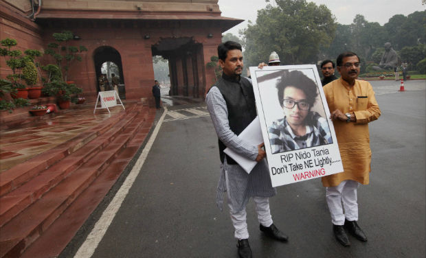 BJP members Tarun Vijay and Anurag Thakur holding a poster of Arunachal Pradesh student Nido Tania, who was killed recently, in Parliament premises during the first day of the extended Winter Session in New Delhi on Wednesday - PTI BJP members Tarun Vijay and Anurag Thakur holding a poster of Arunachal Pradesh student Nido Tania, who was killed recently, in Parliament premises during the first day of the extended Winter Session in New Delhi on Wednesday - PTI